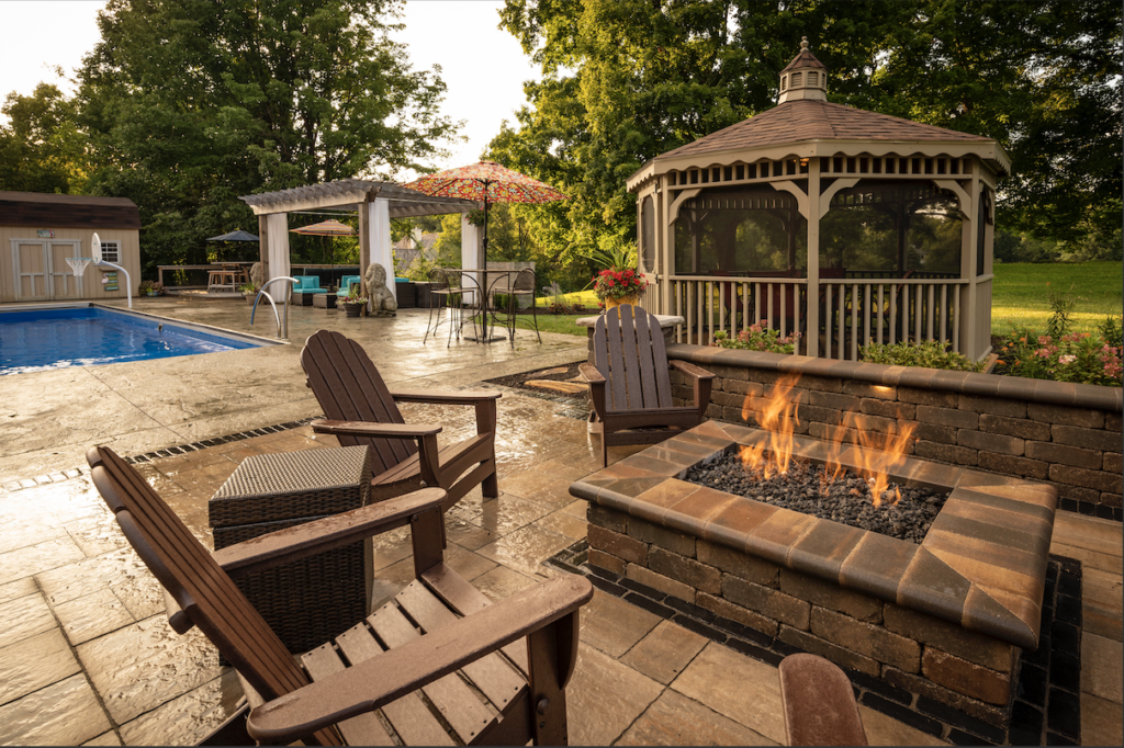 Property Pros backyard complete with a firepit, pool, pergola and gazebo.